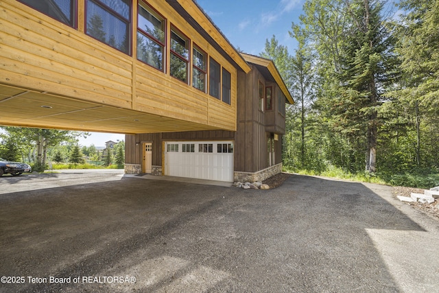 3470 W Mccollister Dr, Teton Village, WY 83025 - view of home's exterior featuring a garage and driveway