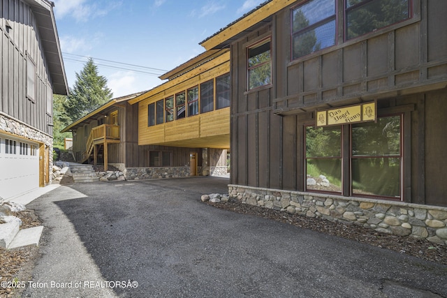3470 W Mccollister Dr, Teton Village, WY 83025 - view of building exterior featuring driveway and a garage