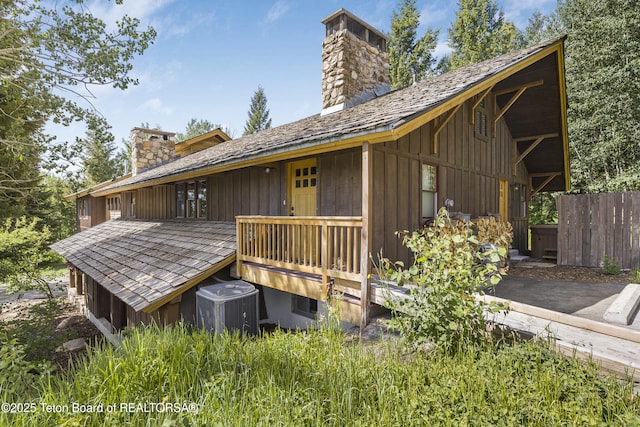 3470 W Mccollister Dr, Teton Village, WY 83025 - back of property with a chimney and board and batten siding