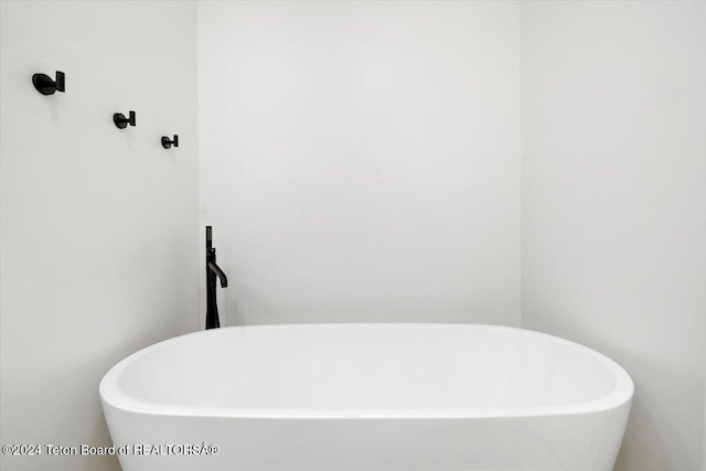 bathroom with a tub to relax in