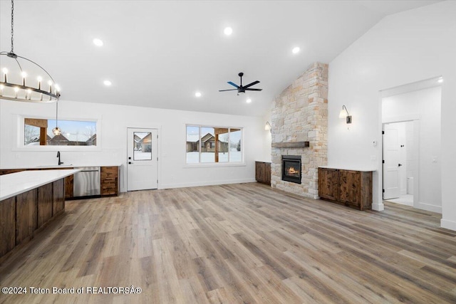 unfurnished living room with light wood-type flooring, plenty of natural light, and high vaulted ceiling