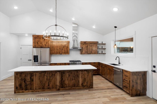 kitchen with appliances with stainless steel finishes, decorative backsplash, decorative light fixtures, lofted ceiling, and a kitchen island