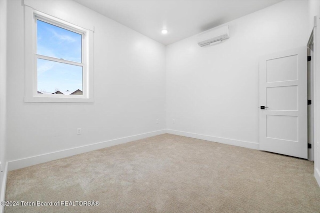 carpeted empty room featuring a wall unit AC