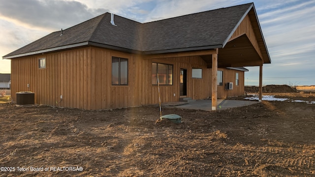 back of property featuring central AC