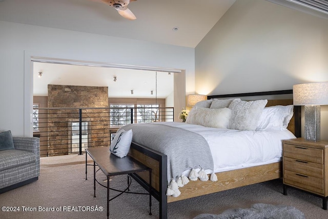 bedroom featuring carpet, ceiling fan, and high vaulted ceiling