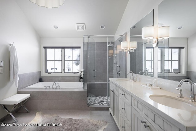 bathroom featuring tile patterned flooring, independent shower and bath, and a healthy amount of sunlight