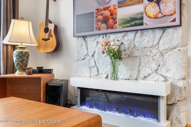 interior details featuring a stone fireplace