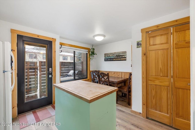 kitchen with white fridge and light hardwood / wood-style flooring