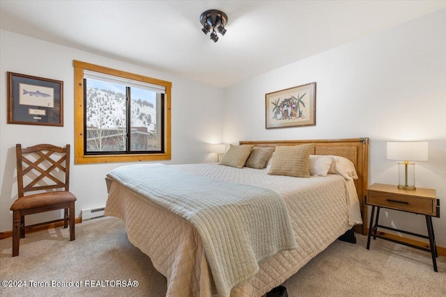 bedroom with baseboard heating and light colored carpet