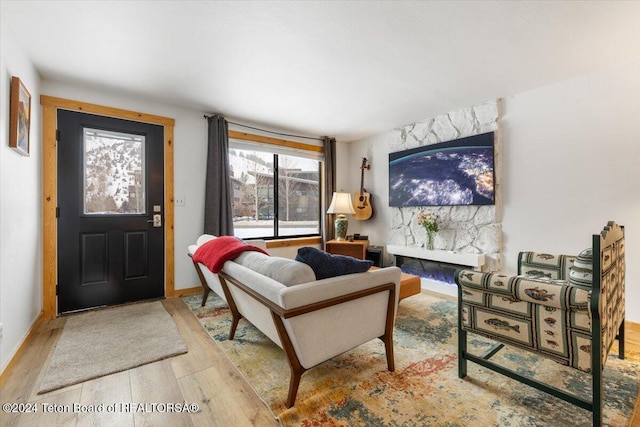 living room featuring a fireplace, hardwood / wood-style floors, and plenty of natural light