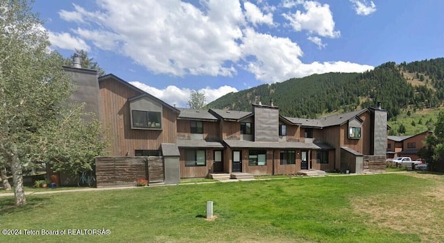 exterior space featuring a mountain view and a yard