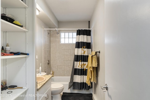 full bathroom featuring vanity, shower / tub combo, and toilet