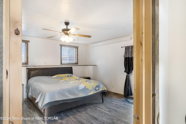 bedroom with ceiling fan and dark hardwood / wood-style floors