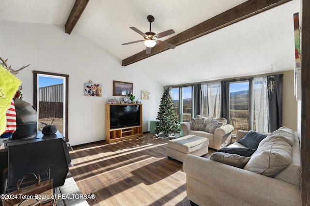 living room with lofted ceiling with beams, hardwood / wood-style flooring, and ceiling fan