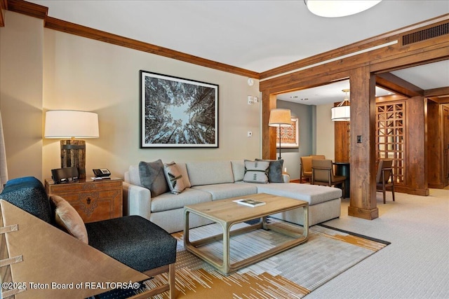 carpeted living room with ornamental molding