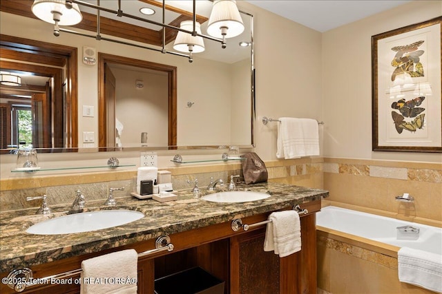 bathroom with tiled bath and vanity