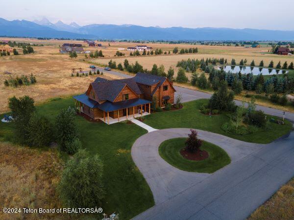 drone / aerial view with a mountain view and a rural view