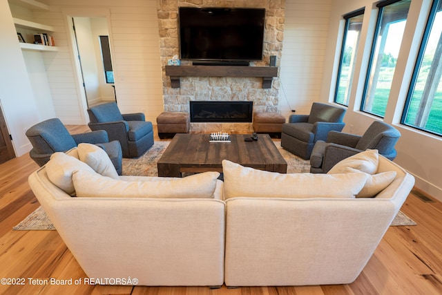 living room with wood-type flooring and a fireplace