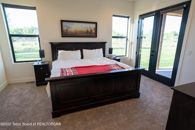 bedroom featuring access to outside and light carpet