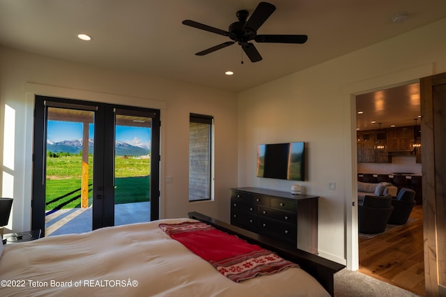 bedroom with ceiling fan, access to exterior, and wood-type flooring