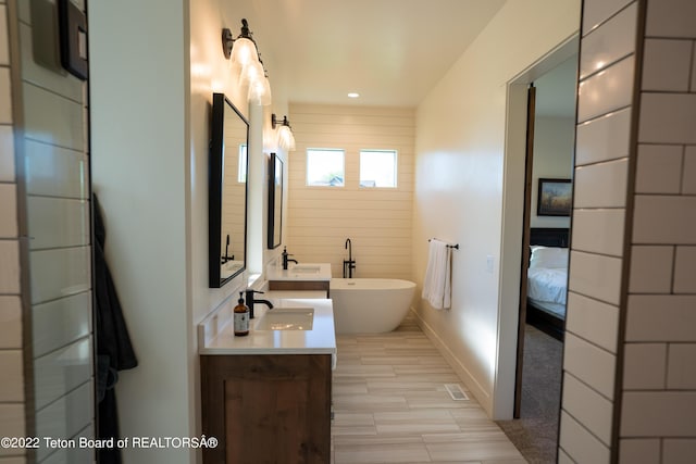 bathroom featuring vanity and a bathing tub