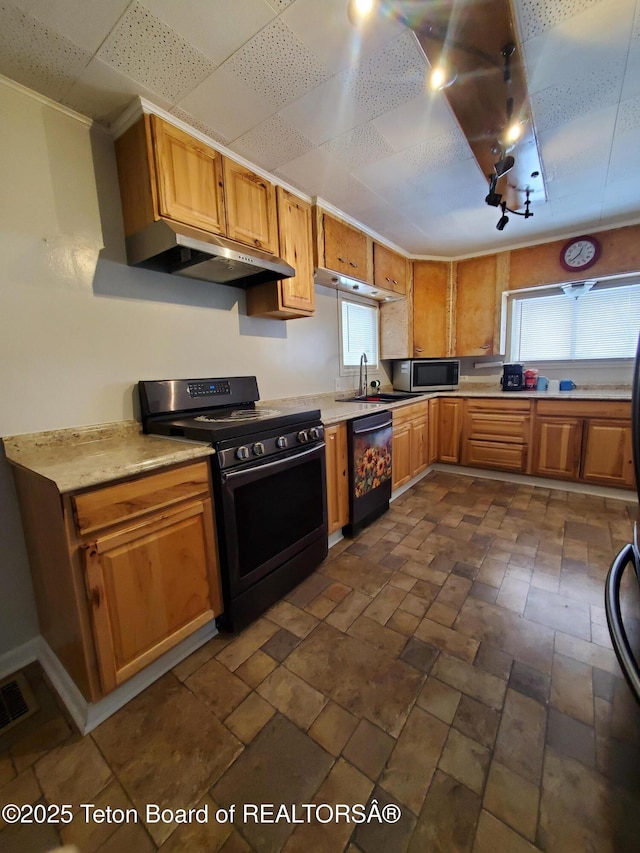 kitchen featuring black appliances, a drop ceiling, and sink