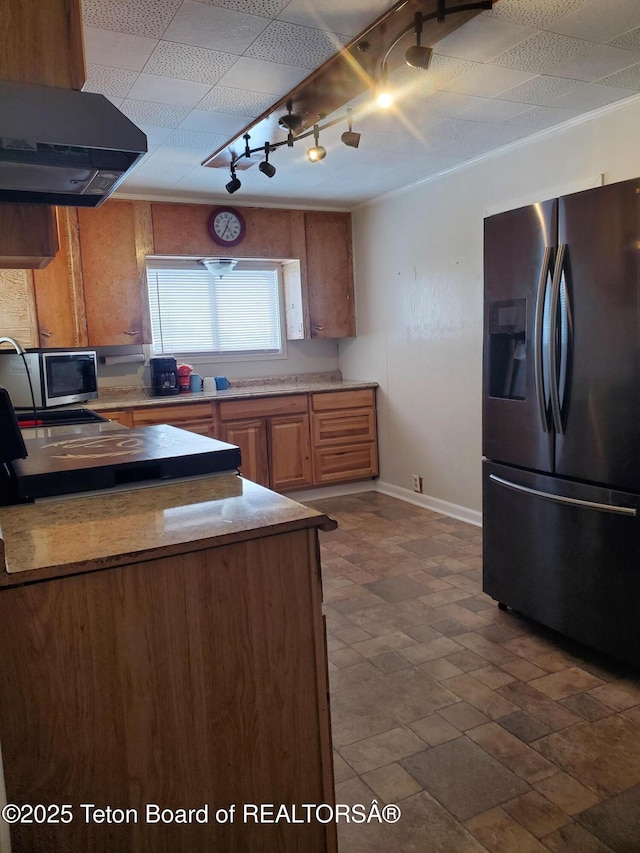 kitchen with ventilation hood, track lighting, and appliances with stainless steel finishes