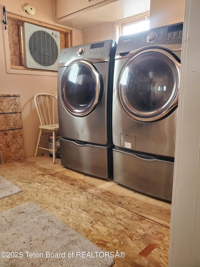 clothes washing area with washer and clothes dryer