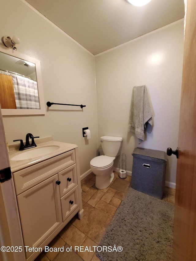 bathroom with vanity, toilet, and walk in shower