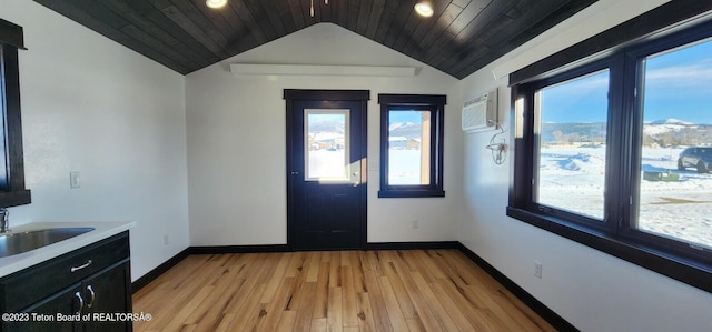 foyer entrance featuring wood ceiling, sink, and vaulted ceiling