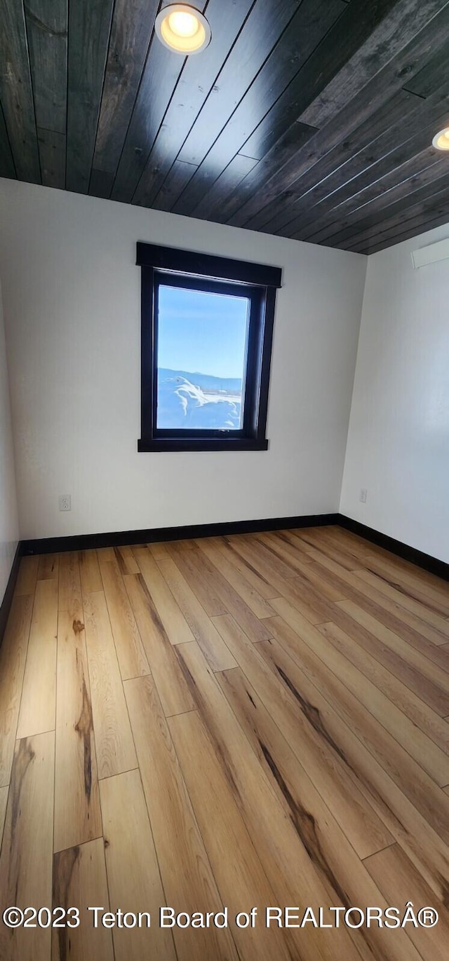 unfurnished room with hardwood / wood-style floors and wood ceiling