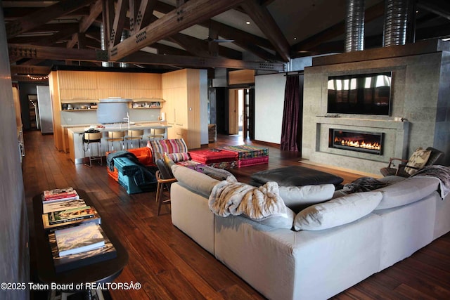 living room with beam ceiling, dark hardwood / wood-style flooring, a premium fireplace, and high vaulted ceiling