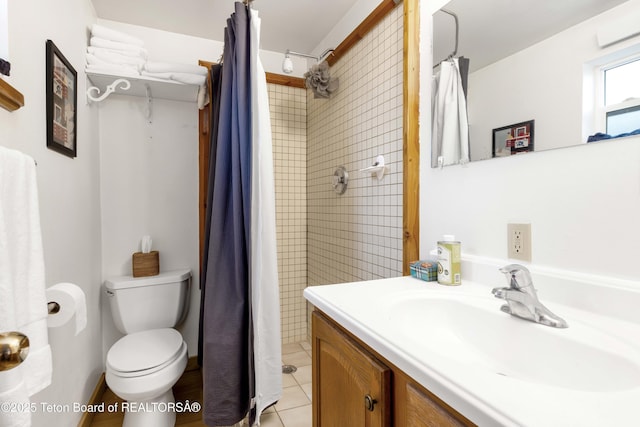 bathroom featuring curtained shower, tile patterned flooring, vanity, and toilet