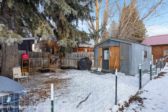 yard layered in snow featuring an outdoor structure