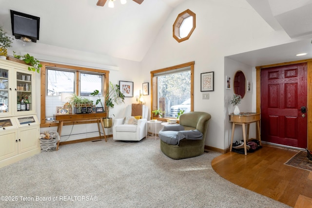 sitting room featuring ceiling fan, high vaulted ceiling, and wood-type flooring