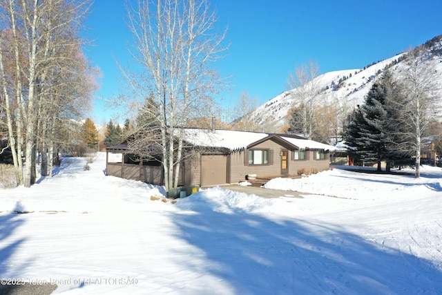 exterior space with a mountain view and a garage