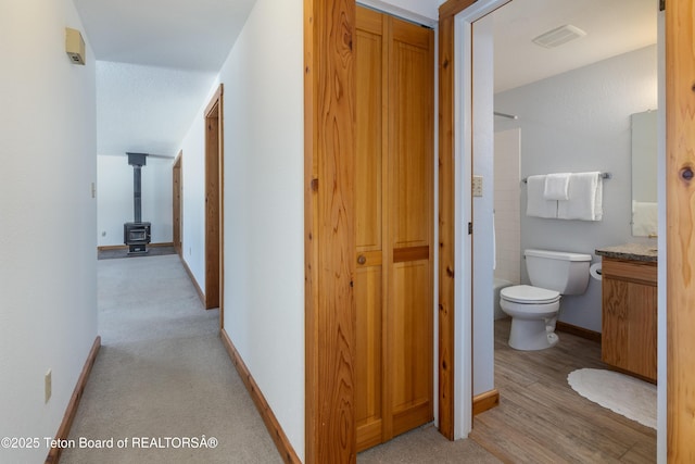 hallway with light hardwood / wood-style flooring