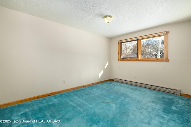 unfurnished room with carpet floors, a textured ceiling, and a baseboard heating unit