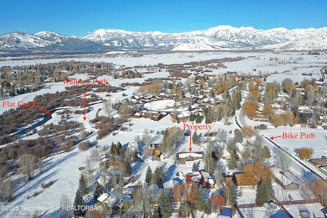 snowy aerial view with a mountain view