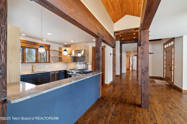 kitchen featuring kitchen peninsula, appliances with stainless steel finishes, sink, decorative light fixtures, and lofted ceiling