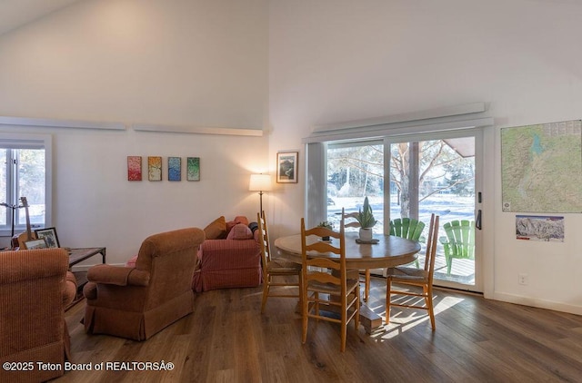 1875 W Cinnamon Teal Rd, Jackson, WY 83001 - dining area with a towering ceiling, wood finished floors, plenty of natural light, and baseboards