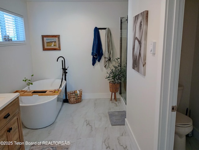 bathroom with a bath, vanity, and toilet