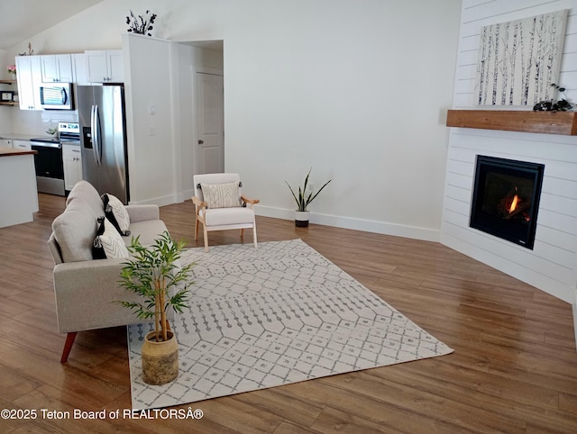 living room with lofted ceiling and hardwood / wood-style flooring