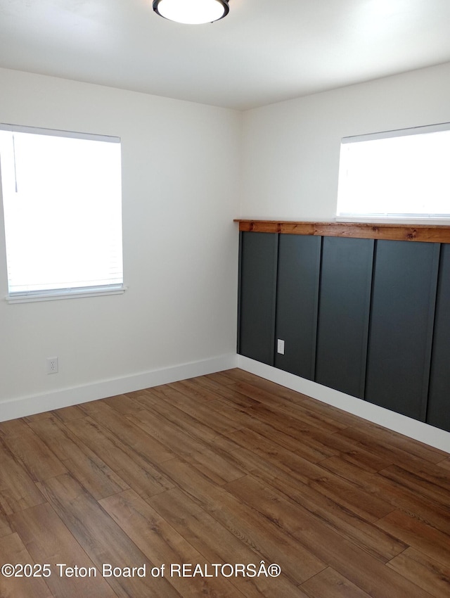 unfurnished room with hardwood / wood-style floors