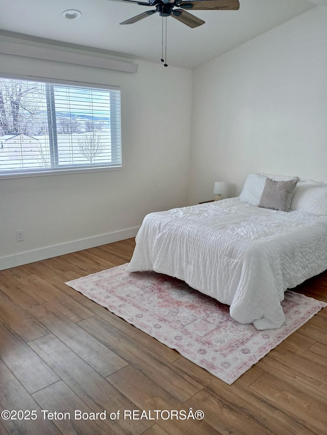 bedroom featuring ceiling fan and wood-type flooring