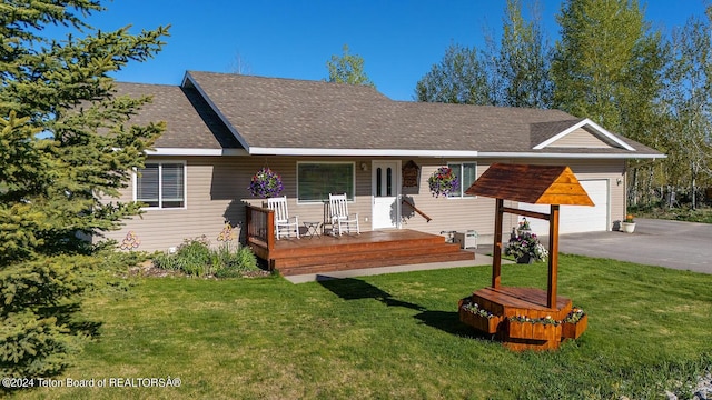 single story home featuring a front yard, a garage, and covered porch