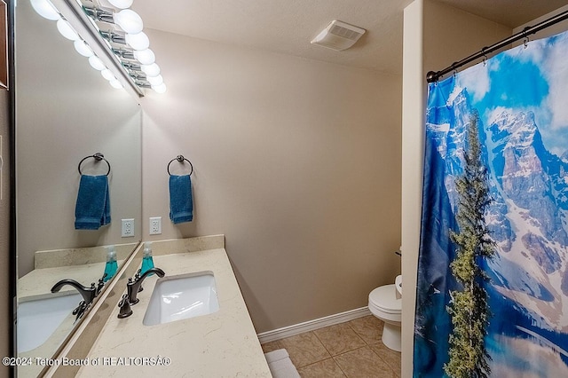 bathroom featuring toilet, vanity, and tile patterned floors