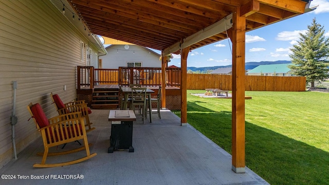 view of patio / terrace with a deck with mountain view