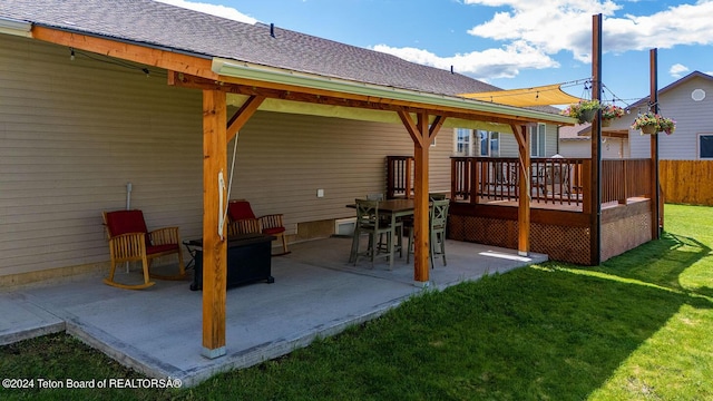 rear view of house featuring a lawn, a patio area, and a deck