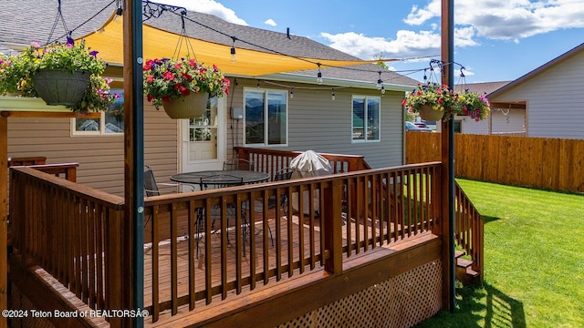 wooden deck with a lawn